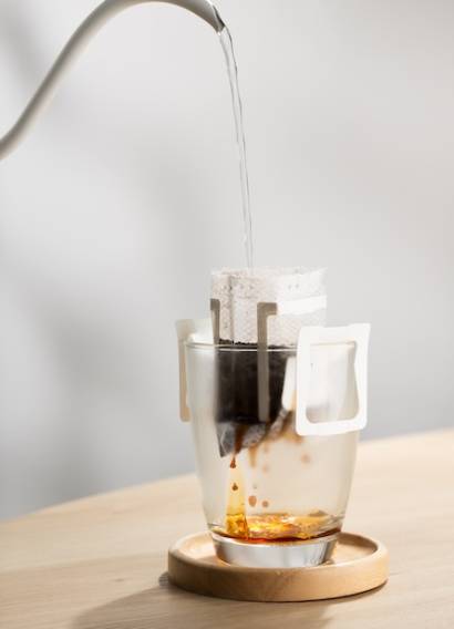 Brewing coffee through pre-made paper filters.